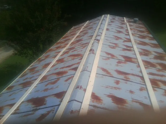 Rusted metal roof panels with new wood purlins before replacement — Storm Damage Roof Repair in Old Bridge by Roofing Brothers