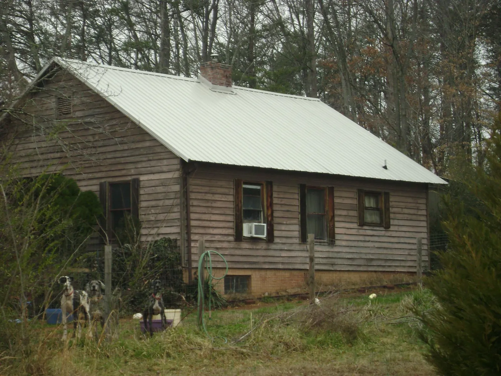 White metal roof on an old wood sided farmhouse, from a Metal Roof Installation job in Old Bridge